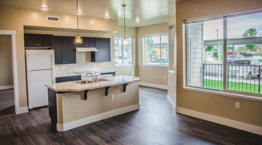 a kitchen with a large window and the dinning area